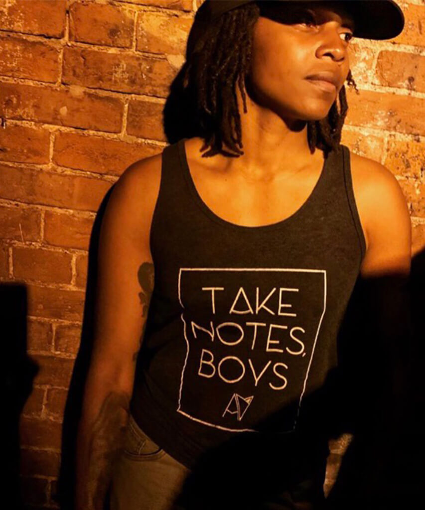 Take Notes Boys tank top in Charcoal Heather on model — gender neutral queer graphic tank