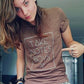 Model wearing brown v-neck 'take notes boys" t-shirt by Androgynous Fox