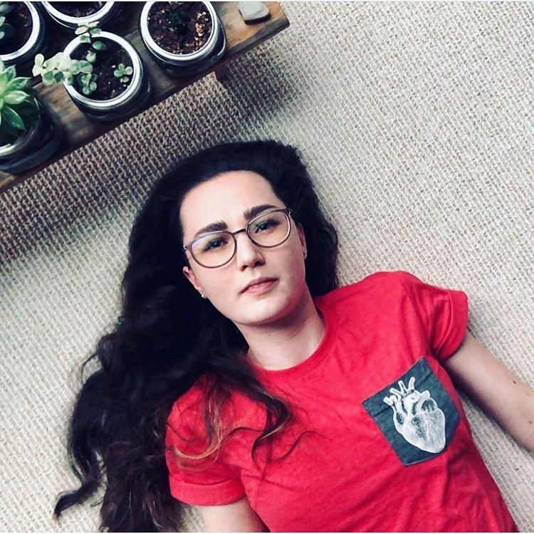 Model wearing crew neck androgynous shirt in red with grey pocket tee showing figure 4 human like you heart. 