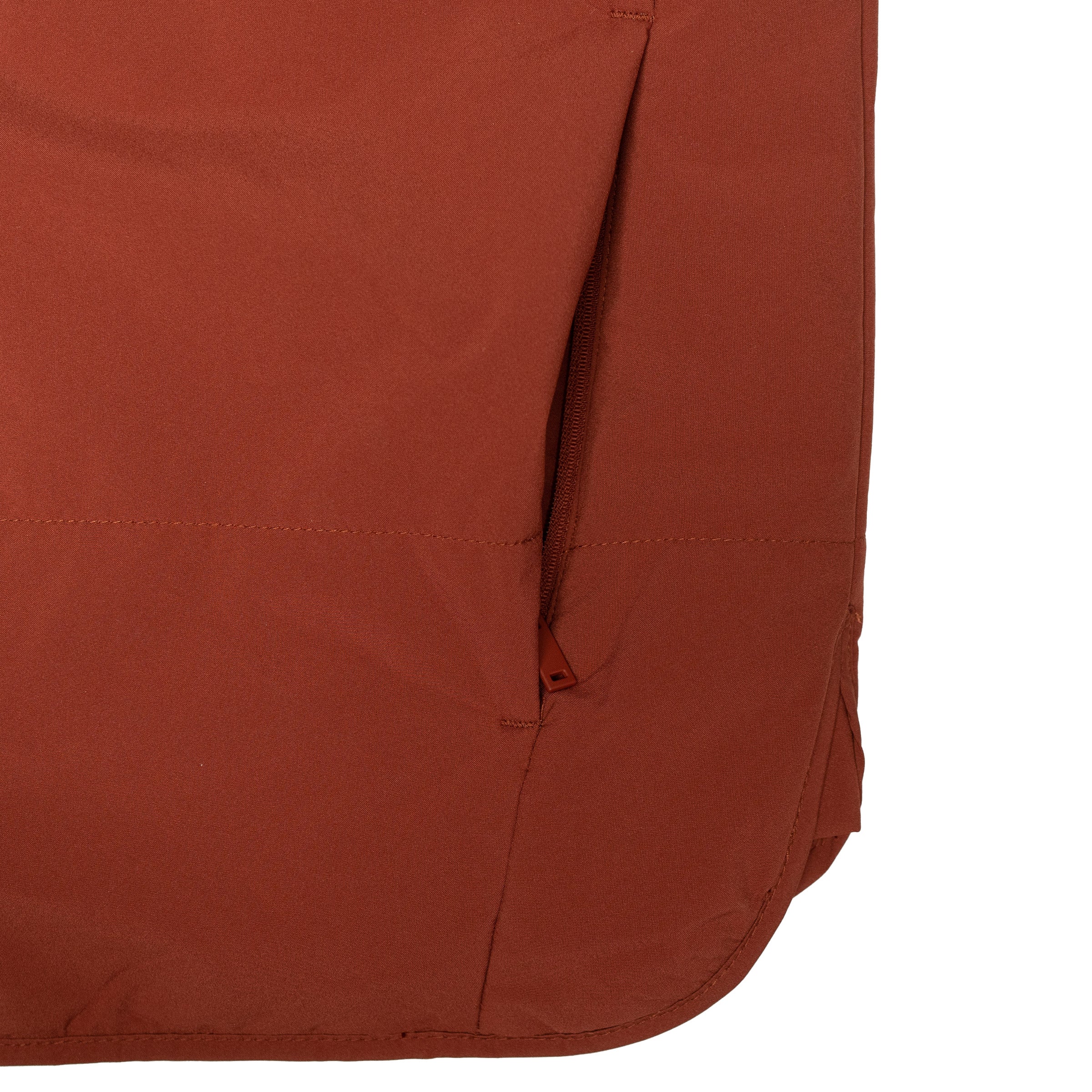Close up of the Beaver Vest zippered hand pocket and curved hem detail