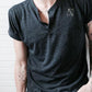 Black triblend henley with cuffed sleeves and Androgynous Fox logo at chest