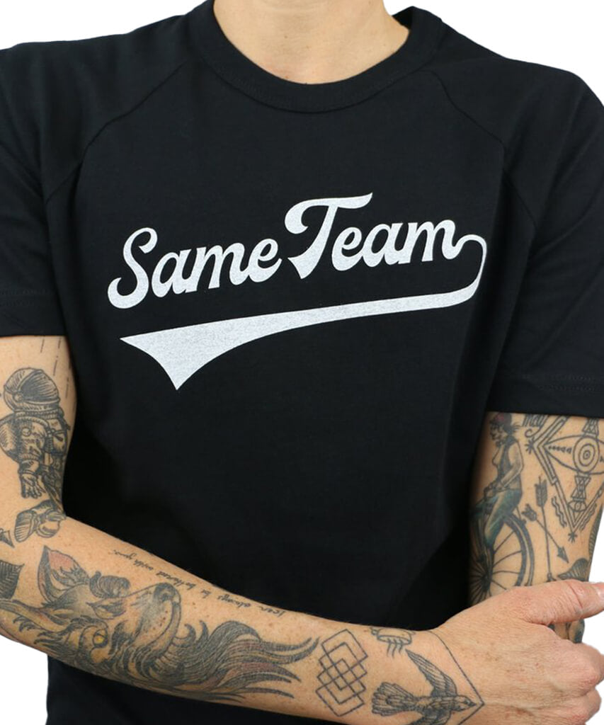 Model wearing Androgynous Fox, 'Same Team', black on black, short sleeve baseball tee